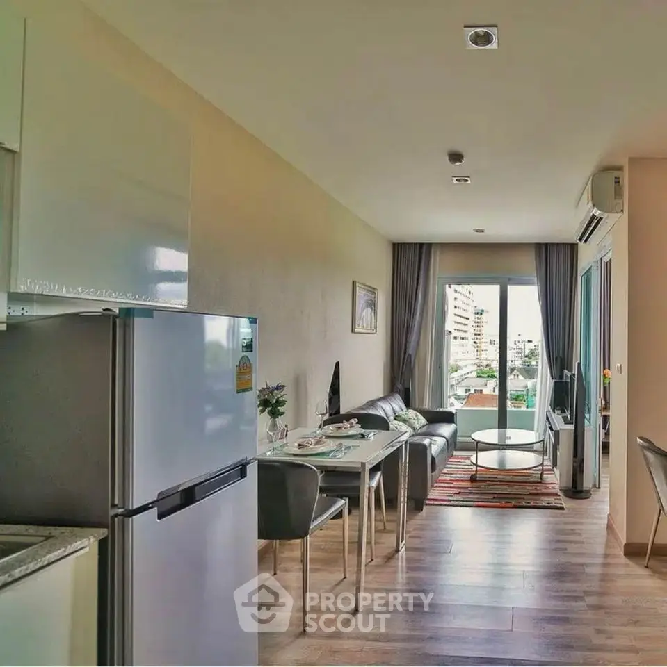 Modern open-plan living room with dining area and city view balcony