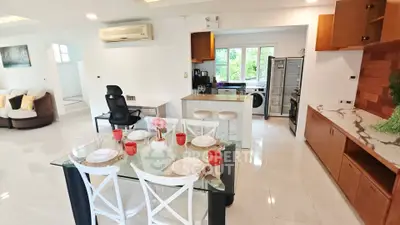 Spacious open-plan living and dining area with modern kitchen and stylish decor.