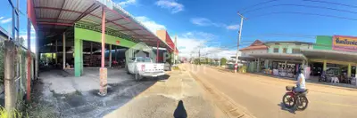 Panoramic view of commercial property with parking and street access