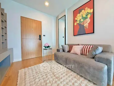Stylish living room with cozy sofa, modern decor, and elegant wooden flooring.