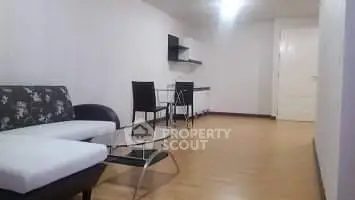 Spacious modern living room with sleek furniture and wooden flooring.