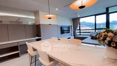 Modern open-plan living room with stylish dining area and scenic view