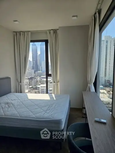 Modern bedroom with city view, large windows, and minimalist decor in urban apartment.