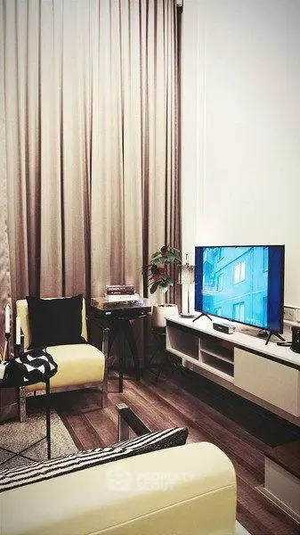 Modern living room with stylish decor, cozy seating, and a flat-screen TV, perfect for relaxation.