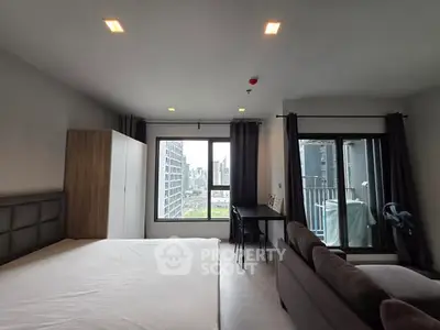Modern studio apartment with city view and balcony access