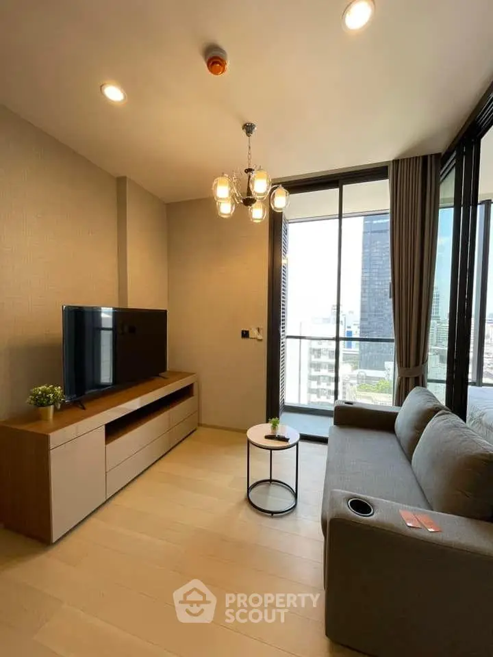 Modern living room with city view, stylish furniture, and natural light.
