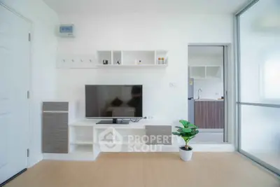 Modern living room with sleek TV unit and open kitchen view