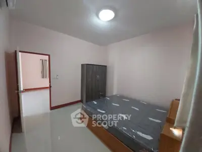 Spacious bedroom with modern wardrobe and comfortable bed in a well-lit apartment.
