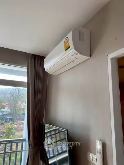 Modern living room with air conditioning and balcony view