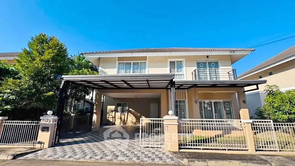 Charming two-story house with spacious driveway and lush greenery, perfect for family living.