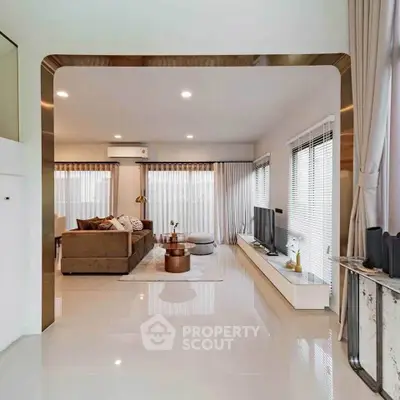 Luxurious modern living room with elegant decor and ample natural light.