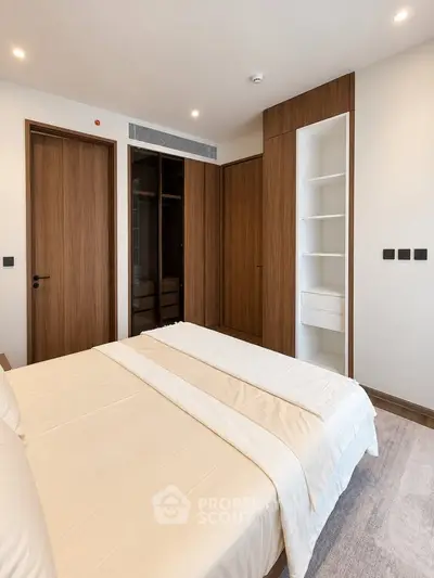 Modern bedroom with wooden accents and built-in closet in a stylish apartment.
