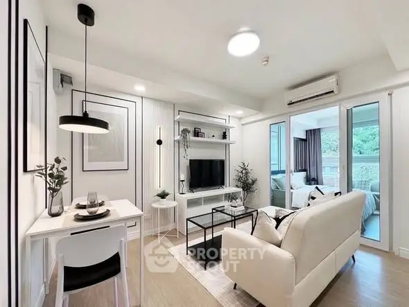 Modern living room with stylish decor and open layout, featuring a cozy dining area and natural light.