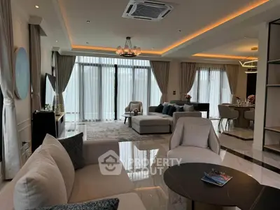 Luxurious modern living room with elegant decor and large windows.