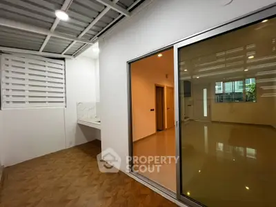 Modern interior with sliding glass doors and tiled flooring, perfect for a cozy living space.