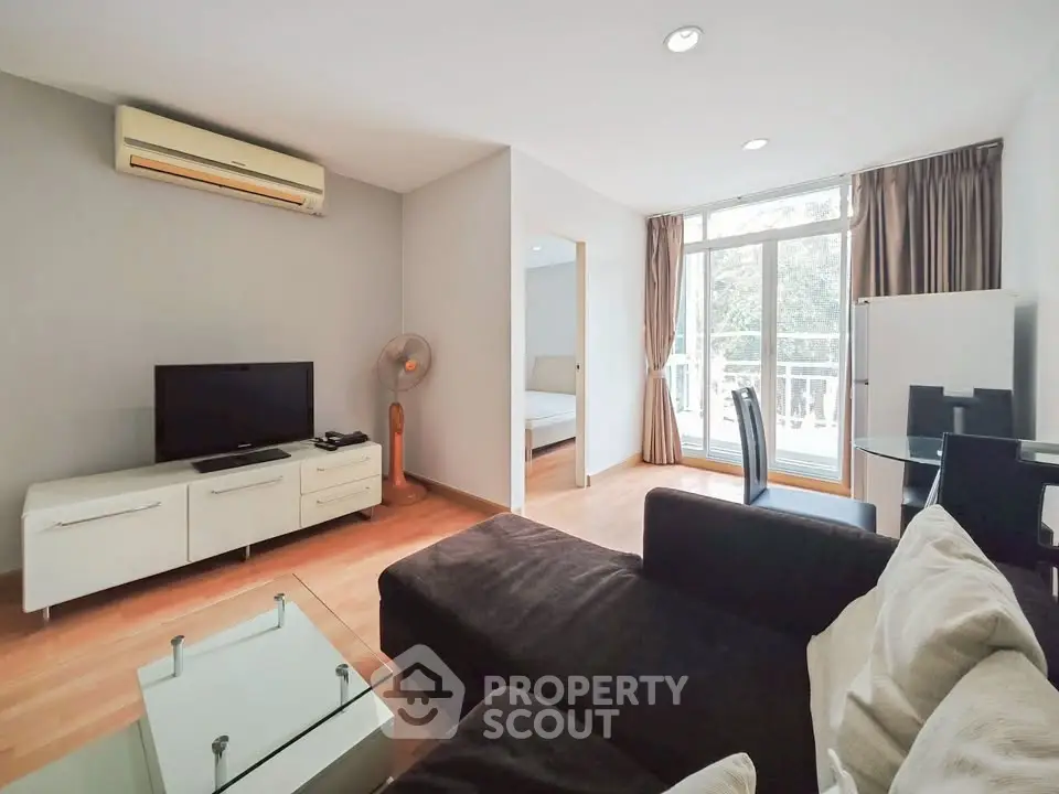 Spacious living room with modern furniture and large windows for natural light.