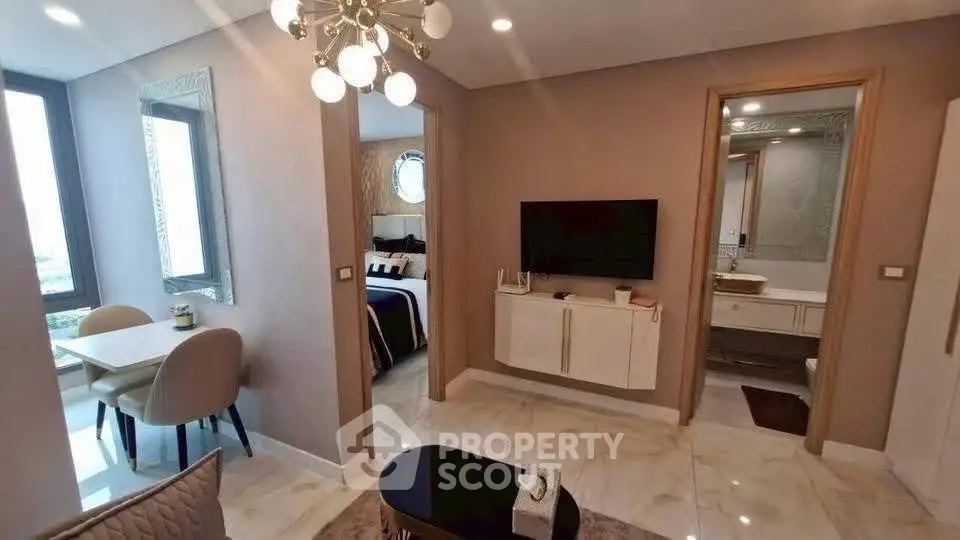 Modern apartment interior with stylish living room, dining area, and bedroom view.