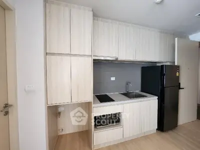 Modern kitchen with sleek cabinetry and built-in appliances in a contemporary apartment.