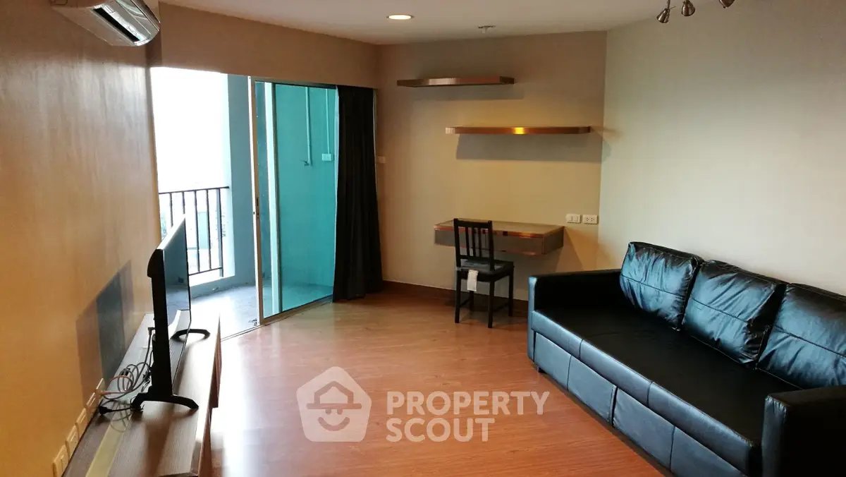 Spacious living room with modern furniture and balcony access