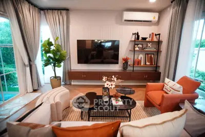 Modern living room with stylish decor, large TV, and cozy seating area, perfect for relaxation and entertainment.