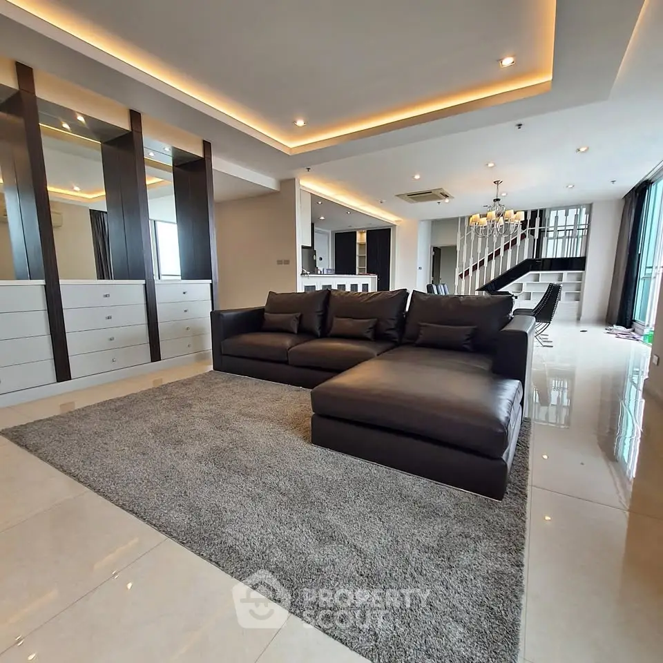 Luxurious modern living room with sleek design and spacious layout, featuring elegant furniture and ambient lighting.