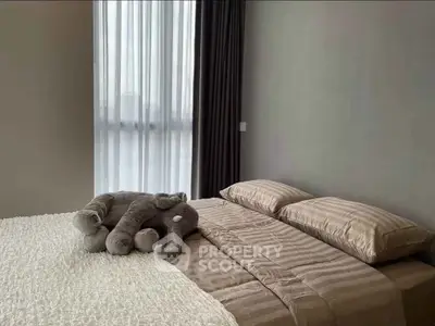 Cozy bedroom with elegant decor and plush elephant toy on bed