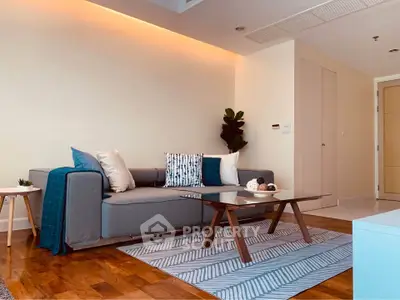 Modern living room with stylish sofa, wooden coffee table, and elegant decor in a cozy apartment.