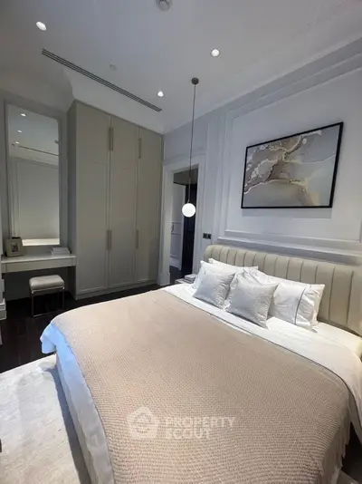 Luxurious bedroom with elegant decor and modern lighting in a stylish apartment.