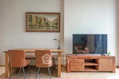 Modern living room with wooden furniture, flat-screen TV, and elegant wall art.