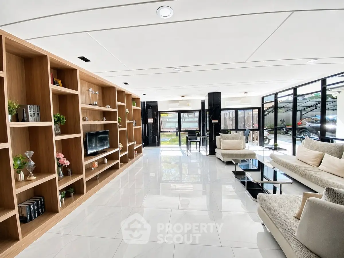 Spacious modern living room with elegant furniture and large windows for natural light.