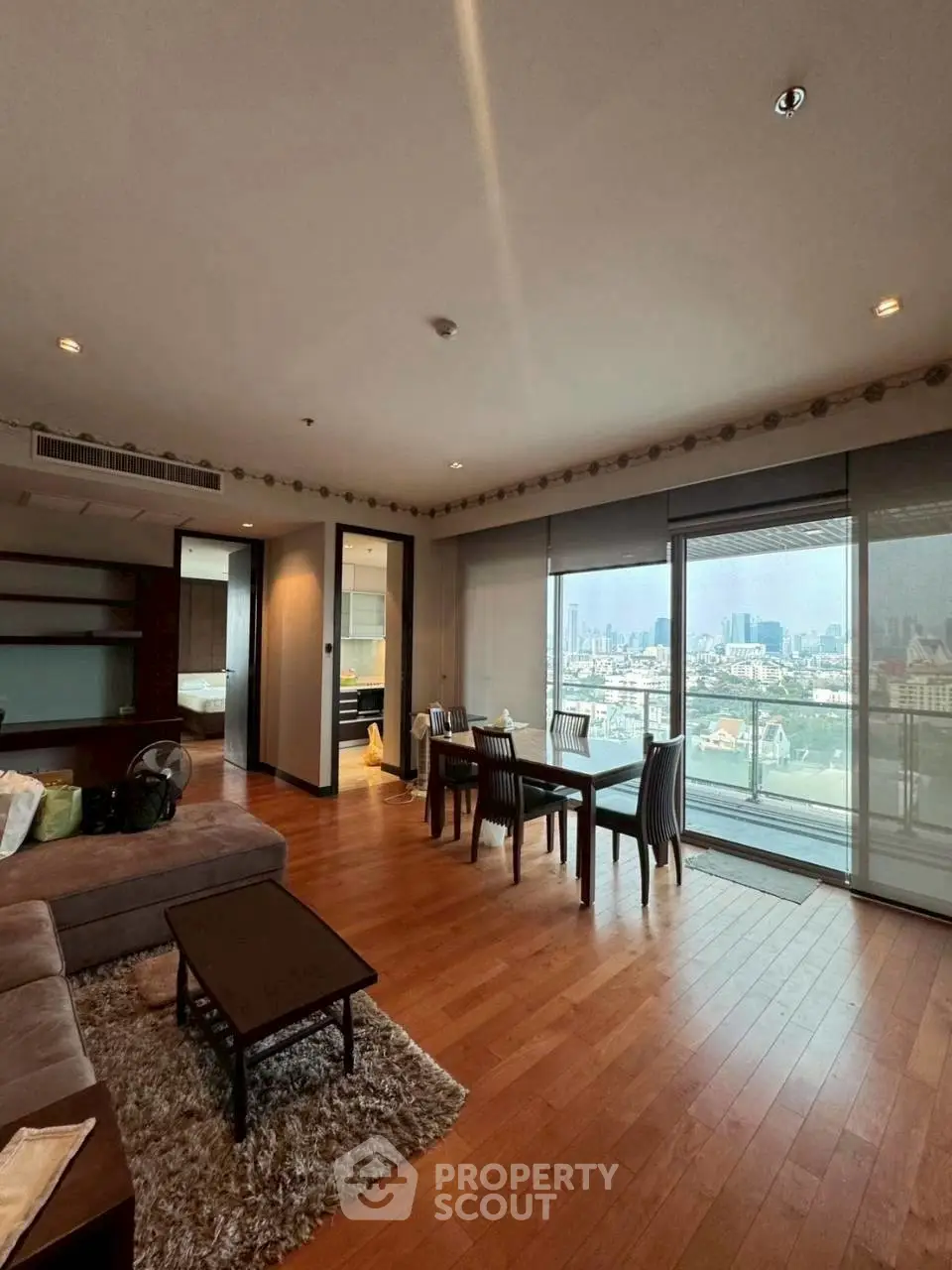 Spacious living room with city view and elegant wooden flooring