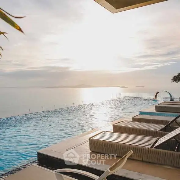 Luxurious infinity pool with stunning ocean view at sunset, perfect for relaxation and leisure.