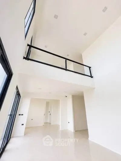 Spacious modern interior with high ceilings and sleek design, perfect for contemporary living.