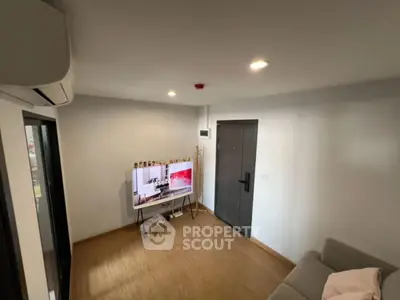 Cozy living room with modern decor and wall-mounted TV