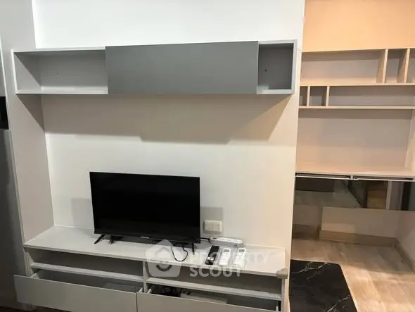 Modern living room with sleek TV unit and ample storage space