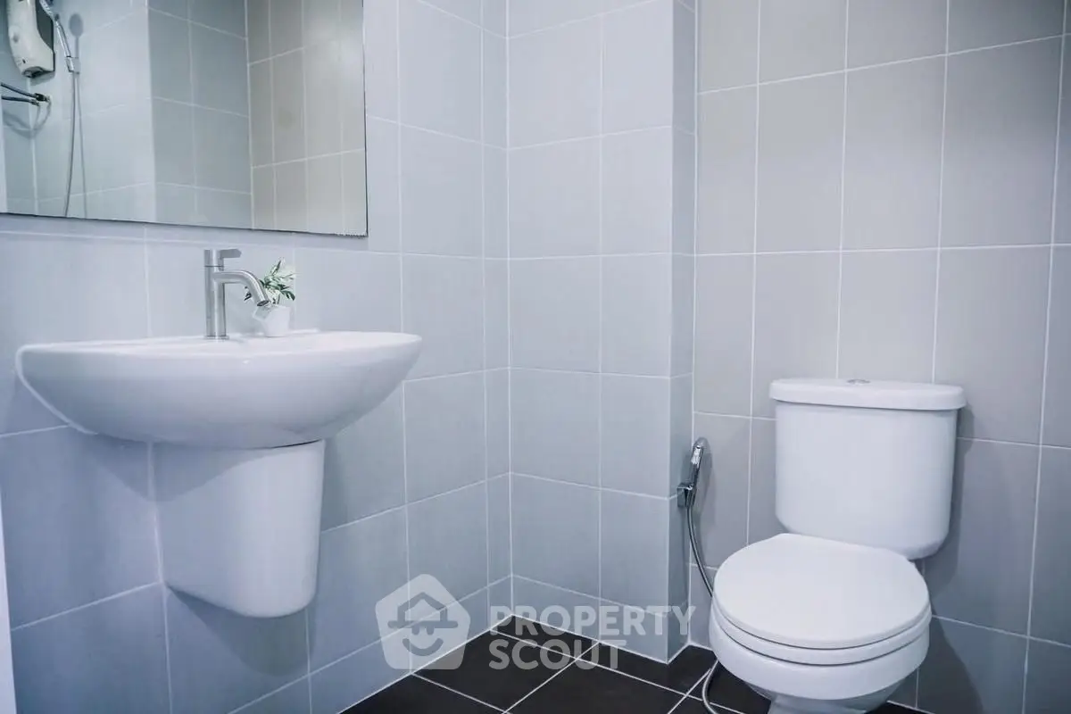Modern bathroom with sleek fixtures and minimalist design in a real estate property.