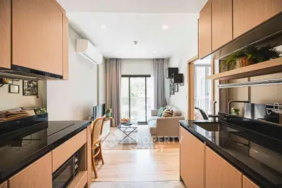 Modern open-layout kitchen and living room with sleek design and natural light