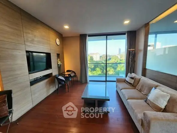 Spacious living room with modern decor and scenic view through large windows.
