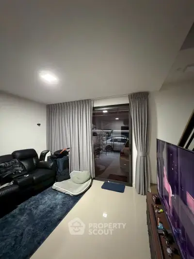 Modern living room with sleek furniture and balcony view