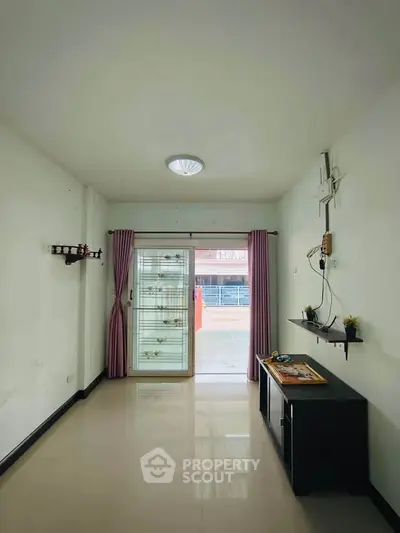 Spacious living room with modern decor and large window view