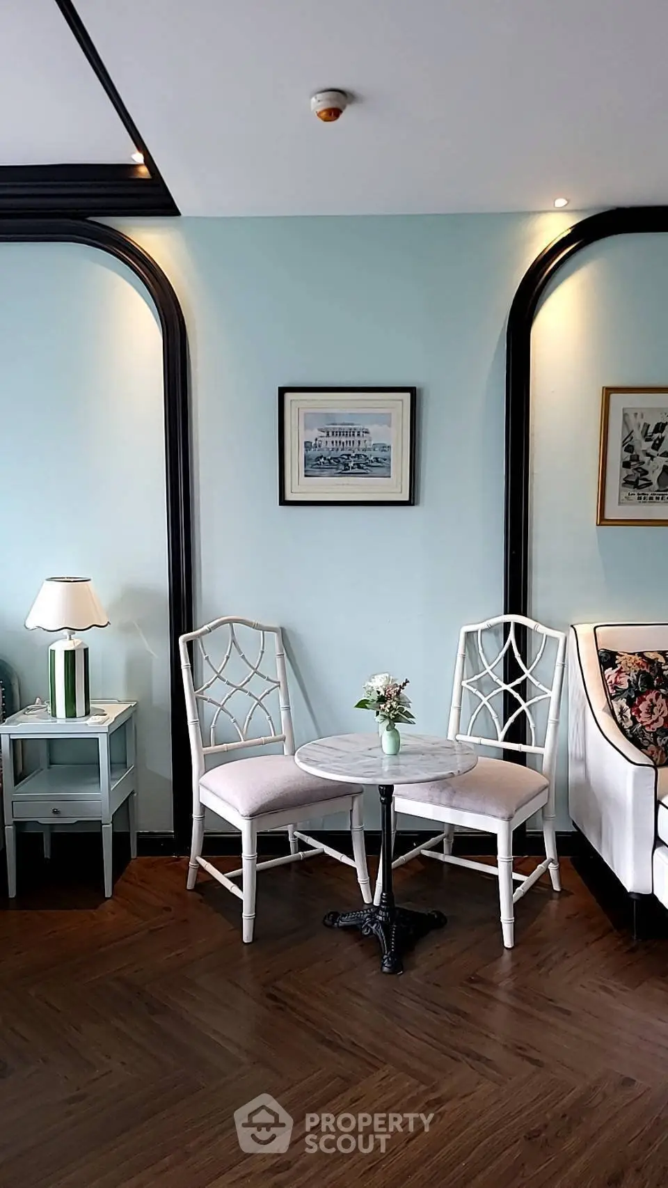 Charming living room corner with elegant chairs and table, perfect for cozy conversations.
