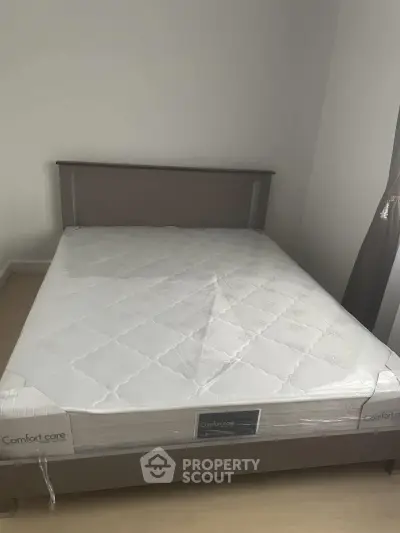Cozy bedroom with a new mattress and elegant bed frame, perfect for restful nights.