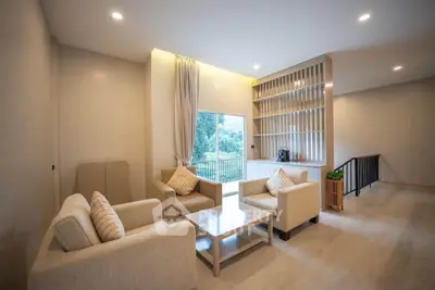 Spacious living room with modern furniture and large window view