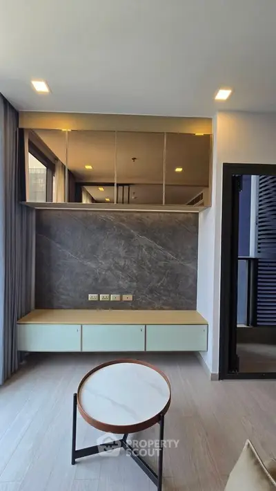 Modern living room with sleek design and large windows for natural light.