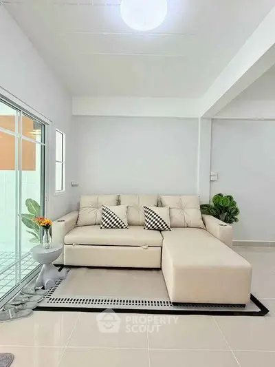 Modern living room with stylish beige sectional sofa and chic decor