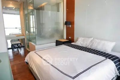 Modern bedroom with glass partition and elegant decor