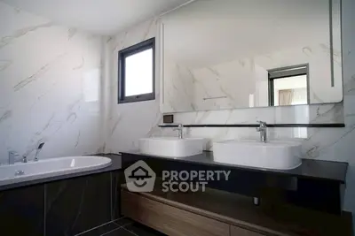 Luxurious modern bathroom with dual sinks and elegant marble finishes