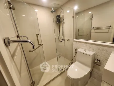Modern bathroom with glass shower enclosure and sleek fixtures