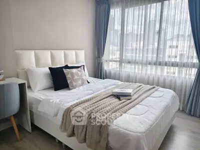 Bright and cozy bedroom with modern decor and city view, perfect for relaxation.