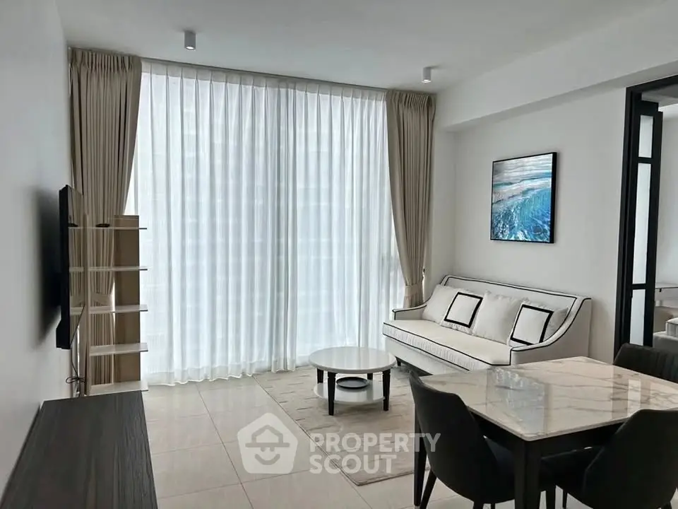 Elegant modern living room with large windows and stylish furniture